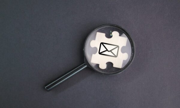 magnifying glass and wooden puzzle with email icon